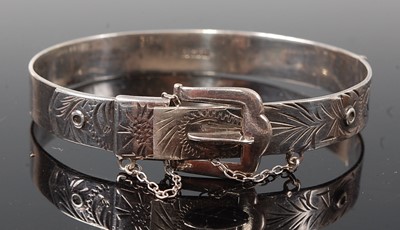 Lot 2623 - A sterling silver oval engraved bangle in the...