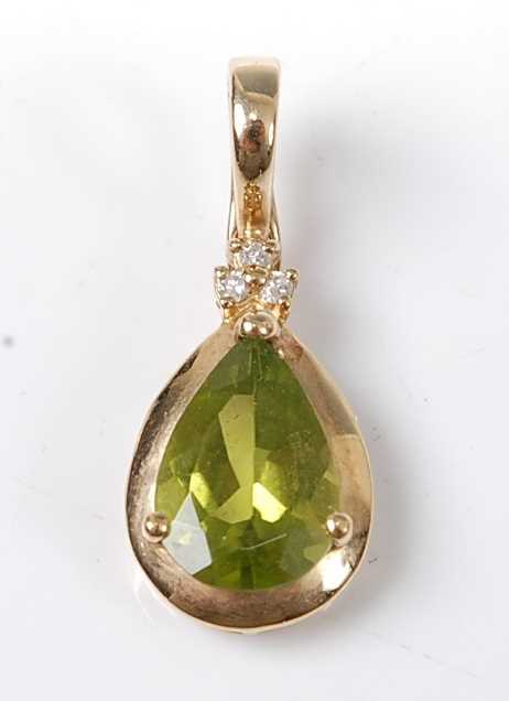 Lot 2588 - A 9ct yellow gold, peridot and diamond pendant,...