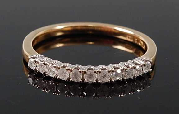 Lot 2607 - A 9ct yellow and white gold diamond half hoop...