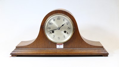 Lot 5 - A 1930s oak cased mantel clock, having a...