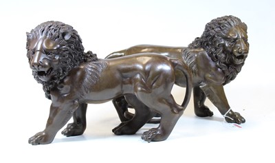 Lot 42 - A pair of modern bronze figures of lions, each...