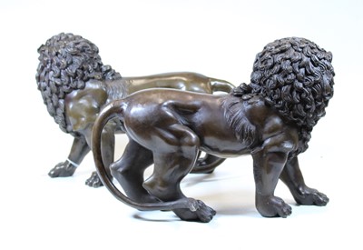 Lot 42 - A pair of modern bronze figures of lions, each...