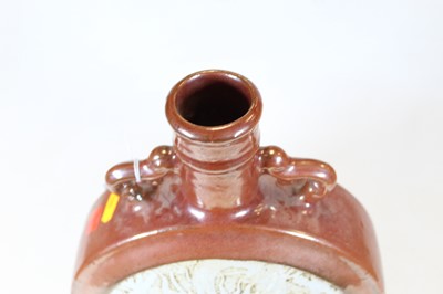 Lot 48 - A Chinese stoneware moon flask, the red lustre...