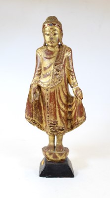 Lot 61 - A carved softwood and gilt painted religious...
