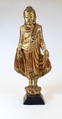 Lot 61 - A carved softwood and gilt painted religious...