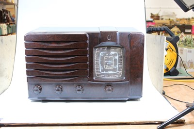 Lot 128 - A mid 20th century brown bakelite cased radio,...