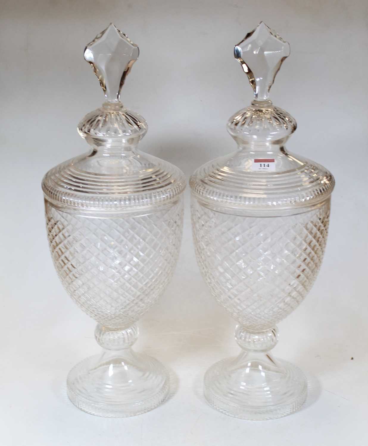Lot 114 - A pair of large clear cut glass jars and...