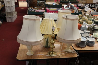 Lot 172 - A set of three turned alabaster table lamps,...