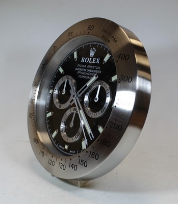 Lot 146 - A brushed aluminium wall clock in the form of...
