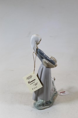Lot 199 - A Lladro figure of a young girl holding a...