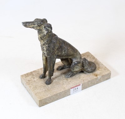 Lot 214 - A spelter model of a wolf hound, in seated...