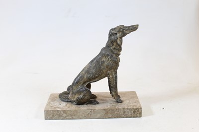 Lot 214 - A spelter model of a wolf hound, in seated...