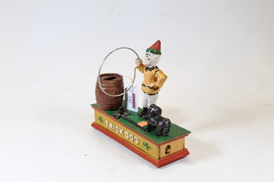 Lot 242 - A reproduction cast iron trick dog novelty...