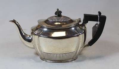 Lot 259 - A George V silver teapot of oval half reeded...