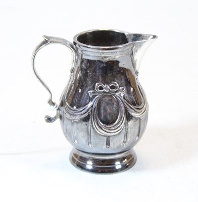 Lot 263 - A silver cream jug, having embossed swag and...
