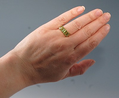 Lot 2619 - A 9ct yellow gold peridot dress ring,...