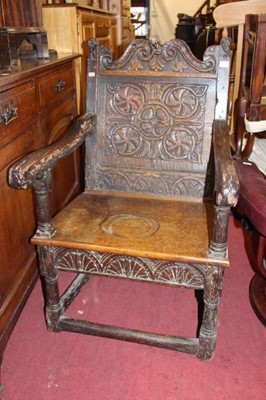 Lot 1432 - An antique relief carved oak panelled seat...
