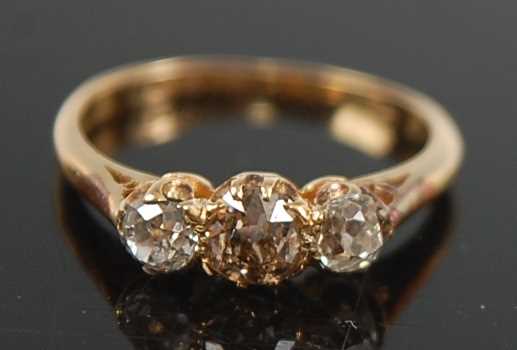 Lot 2637 - A yellow metal diamond three-stone ring,...