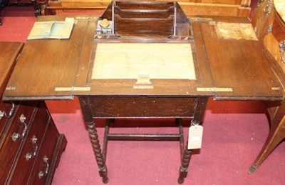 Lot 1490 - An early 20th century oak twin hinged top...