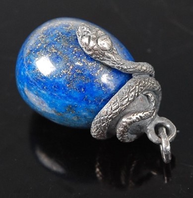 Lot 390 - A white metal and blue hardstone snake pendant