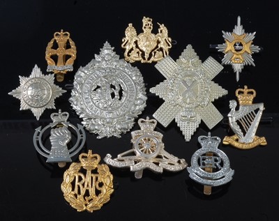 Lot 2451 - A collection of re-strike cap badges to...