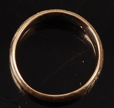 Lot 2668 - A yellow metal 4.5mm D shaped wedding band...