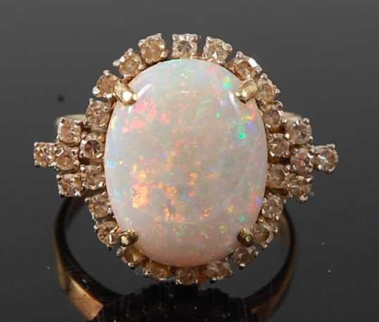 Lot 2666 - A yellow and white metal opal and diamond oval...