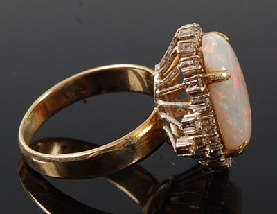 Lot 2666 - A yellow and white metal opal and diamond oval...