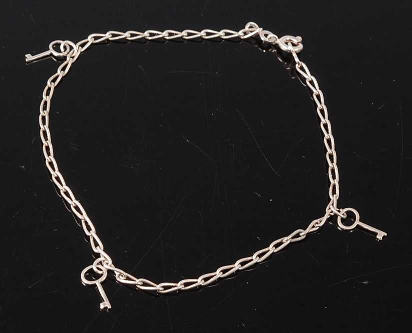 Lot 2679 - A white metal elongated curb link anklet with...