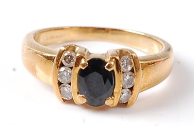 Lot 2694 - A yellow metal sapphire and diamond dress ring...
