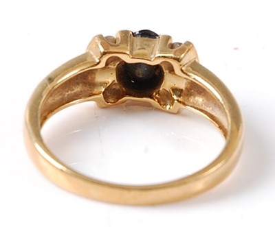 Lot 2694 - A yellow metal sapphire and diamond dress ring...