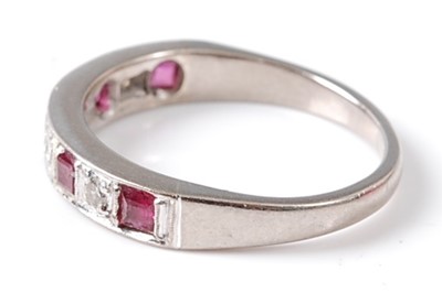 Lot 2695 - An 18ct white gold ruby and diamond half hoop...