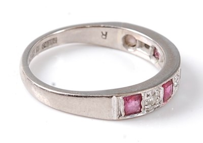 Lot 2695 - An 18ct white gold ruby and diamond half hoop...