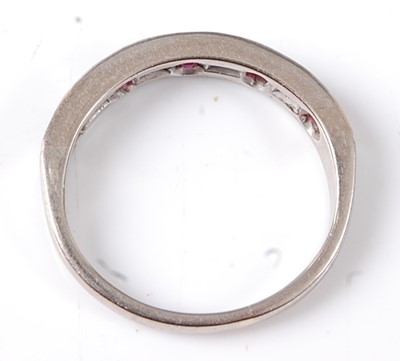 Lot 2695 - An 18ct white gold ruby and diamond half hoop...