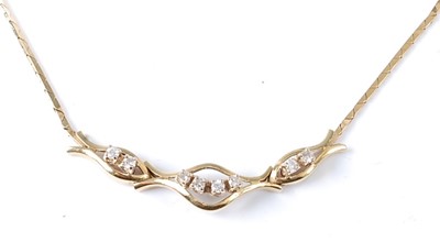 Lot 2710 - A yellow metal diamond necklet featuring a...