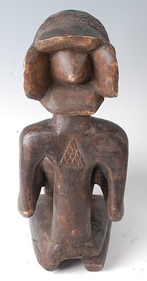 Lot 84 - * A carved wooden figure in kneeling pose with...
