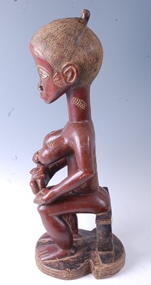 Lot 218 - * A large maternity figure carved as a female...