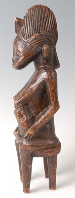 Lot 62 - * A maternity figure, carved as a female in...