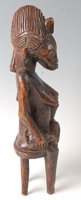 Lot 62 - * A maternity figure, carved as a female in...