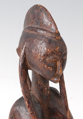 Lot 63 - * A maternity figure, carved as a seated...