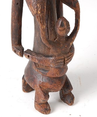 Lot 63 - * A maternity figure, carved as a seated...