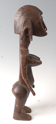 Lot 67 - * An ancestor figure, carved as a nude female...