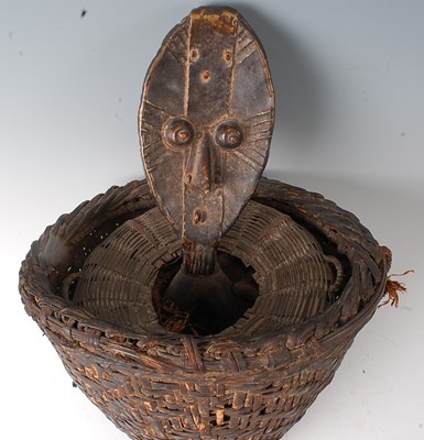 Lot 79 - * A woven rattan reliquary basket, complete...