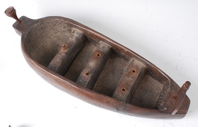Lot 135 - * A large carved hardwood model of a boat with...