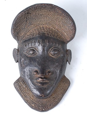 Lot 137 - * A cast copper alloy currency mask, Bamun,...