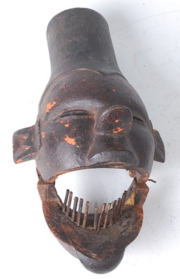 Lot 109 - * A carved initiation mask, having a hinged...
