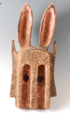 Lot 112 - * A large carved wooden funeral mask, having...