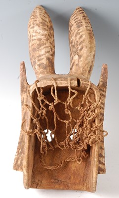 Lot 112 - * A large carved wooden funeral mask, having...