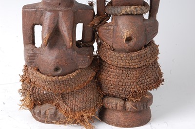 Lot 119 - * A pair of wooden fetish figures, carved as a...
