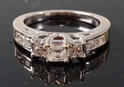Lot 2783 - A white metal diamond three stone ring...